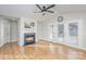 Bright living room featuring a fireplace, ceiling fan, and french doors, complemented by light wood flooring at 1720 Dewberry Pl, Salisbury, NC 28146