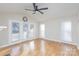 Spacious open living room featuring wood floors, ceiling fan, and access to the outside at 1720 Dewberry Pl, Salisbury, NC 28146