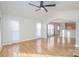 Bright living room featuring wood floors, an open floor plan, ceiling fan, and large windows at 1720 Dewberry Pl, Salisbury, NC 28146
