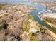 Aerial view showcases a waterfront community with boat docks, lush greenery, and stunning lake views at 20105 Chapel Point Ln, Cornelius, NC 28031