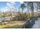 Lush backyard with sprawling lawn leading to the lake and private dock at 20105 Chapel Point Ln, Cornelius, NC 28031