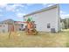 Spacious backyard featuring a wooden playset and ample green space for outdoor activities at 205 Falls Cove Dr, Troutman, NC 28166