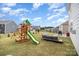 Large backyard with a playset, patio seating, and plenty of space for outdoor fun at 205 Falls Cove Dr, Troutman, NC 28166