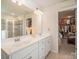 Bright bathroom with dual sinks, walk-in shower, and a spacious walk-in closet for storage at 205 Falls Cove Dr, Troutman, NC 28166