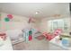 Bright bedroom featuring whimsical decorations, twin beds, and a playhouse for a -friendly atmosphere at 205 Falls Cove Dr, Troutman, NC 28166
