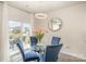 Bright breakfast nook with round table, four blue chairs, and views of the outdoor patio at 205 Falls Cove Dr, Troutman, NC 28166