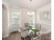 Formal dining room with elegant glass table, seating for six, and modern chandelier at 205 Falls Cove Dr, Troutman, NC 28166