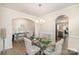 Formal dining room with elegant glass table, seating for six, and modern chandelier at 205 Falls Cove Dr, Troutman, NC 28166