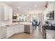 Modern kitchen with stainless steel appliances, white cabinets, and an open view of the living and dining area at 205 Falls Cove Dr, Troutman, NC 28166