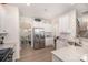 Bright kitchen with stainless steel appliances, white cabinetry, and open access to the dining area at 205 Falls Cove Dr, Troutman, NC 28166