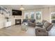 Cozy living room with fireplace, TV, and comfortable gray seating, ideal for relaxation at 205 Falls Cove Dr, Troutman, NC 28166