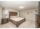 Spacious main bedroom features a large wooden bed frame and stylish furnishings at 205 Falls Cove Dr, Troutman, NC 28166