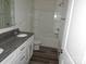 Modern bathroom with a bathtub, granite countertop and dual sinks at 232 Sugar Hill Rd, Troutman, NC 28166