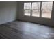 Bright bedroom features modern gray floors and three large windows at 232 Sugar Hill Rd, Troutman, NC 28166