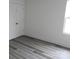 Bright bedroom features modern gray floors and a closet at 232 Sugar Hill Rd, Troutman, NC 28166