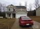 Charming two-story home features a red car parked on the driveway at 232 Sugar Hill Rd, Troutman, NC 28166