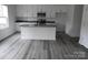 Modern kitchen with white cabinets, gray counters, and a large island at 232 Sugar Hill Rd, Troutman, NC 28166
