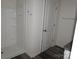 Modern bathroom with white shower, dark floors, granite vanity, and chrome hardware at 248 Mills Ave, Troutman, NC 28166