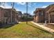 A shared backyard lawn provides a greenspace for the condominium complex residents at 2607 Vail Ave, Charlotte, NC 28207