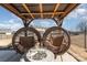 Backyard patio featuring two hanging chairs with a gas fire pit table in the center at 2638 Trinity St, Monroe, NC 28110