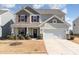 Charming two-story home with a well-manicured lawn and a two car garage at 2638 Trinity St, Monroe, NC 28110