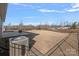Large backyard with a stone patio, fire pit, and black metal fence at 3012 Seville St, Charlotte, NC 28214