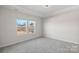 Bright bedroom with plush carpet and large windows offering community views at 3012 Seville St, Charlotte, NC 28214