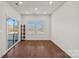 Bonus room featuring hardwood floors, natural light, and glass sliding doors at 3012 Seville St, Charlotte, NC 28214