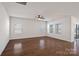 Spacious living room featuring hardwood floors, a ceiling fan, and lots of natural light at 3012 Seville St, Charlotte, NC 28214