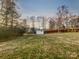 Expansive backyard featuring a large lawn, storage shed, and privacy fence at 316 Epperstone Ln, Matthews, NC 28105
