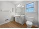 Bright bathroom with modern fixtures, hardwood floors, and ample counter space at 316 Epperstone Ln, Matthews, NC 28105