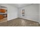 A dining room featuring chair rail, hardwood floors, and a bright window at 316 Epperstone Ln, Matthews, NC 28105