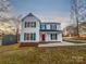 Charming two-story home with white siding, green shutters and a vibrant red front door at 316 Epperstone Ln, Matthews, NC 28105