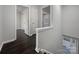 An upstairs hallway with hardwood floors and doors to the bedrooms at 316 Epperstone Ln, Matthews, NC 28105