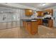 An updated kitchen with stainless steel appliances, dark countertops, and tile flooring at 316 Epperstone Ln, Matthews, NC 28105