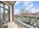 Balcony with decorative chairs overlooking the parking lot and bare trees at 3920 Sharon Rd # 208, Charlotte, NC 28211