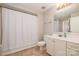 Bathroom with shower-tub combo, vanity and cabinet storage; view into bedroom at 3920 Sharon Rd # 208, Charlotte, NC 28211