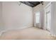 Bright bedroom with neutral carpet, natural light from a window and a door to a balcony at 3920 Sharon Rd # 208, Charlotte, NC 28211