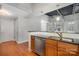 Well-equipped kitchen with a modern sink, stainless steel dishwasher, and bar seating for casual dining at 3920 Sharon Rd # 208, Charlotte, NC 28211