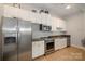Well-equipped kitchenette featuring stainless steel appliances and ample cabinet space for convenience at 3920 Sharon Rd # 208, Charlotte, NC 28211