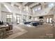 Elegant community lounge features high ceilings, modern lighting, and a comfortable seating area with a cozy fireplace at 3920 Sharon Rd # 208, Charlotte, NC 28211