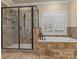 Luxurious bathroom showcasing walk-in shower, soaking tub, and tiled surround at 462 Barber Loop, Mooresville, NC 28117