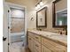 Bright bathroom featuring a double vanity, granite countertop, framed mirrors, and a shower-tub combo at 462 Barber Loop, Mooresville, NC 28117