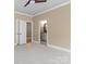 Bright bedroom with neutral paint and trim and a view of the en suite bathroom at 462 Barber Loop, Mooresville, NC 28117