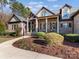 Inviting front yard showcasing a beautifully landscaped entrance, stone accents, and a classic American flag display at 462 Barber Loop, Mooresville, NC 28117