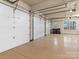 Spacious three car garage with epoxy flooring providing ample parking and storage at 462 Barber Loop, Mooresville, NC 28117