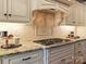 Close-up of the kitchen featuring granite countertops, custom cabinets, and a gas cooktop at 462 Barber Loop, Mooresville, NC 28117