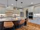 Elegant kitchen features custom cabinets, granite counters, island with seating, and stainless steel appliances at 462 Barber Loop, Mooresville, NC 28117