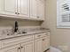 Charming laundry room featuring a granite countertop, shaker cabinets, and modern sink at 462 Barber Loop, Mooresville, NC 28117