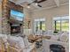 Cozy living room featuring a stone fireplace, built-in shelving, and comfortable seating with natural light at 462 Barber Loop, Mooresville, NC 28117